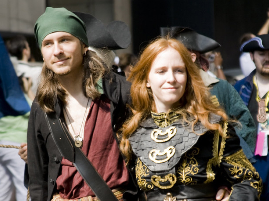 Two people dressed as pirates in the city.